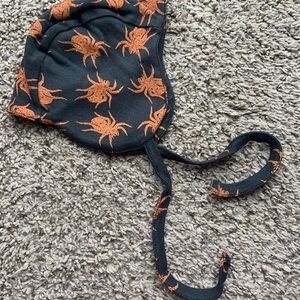Kate Quinn orange and black spiders flight hat.